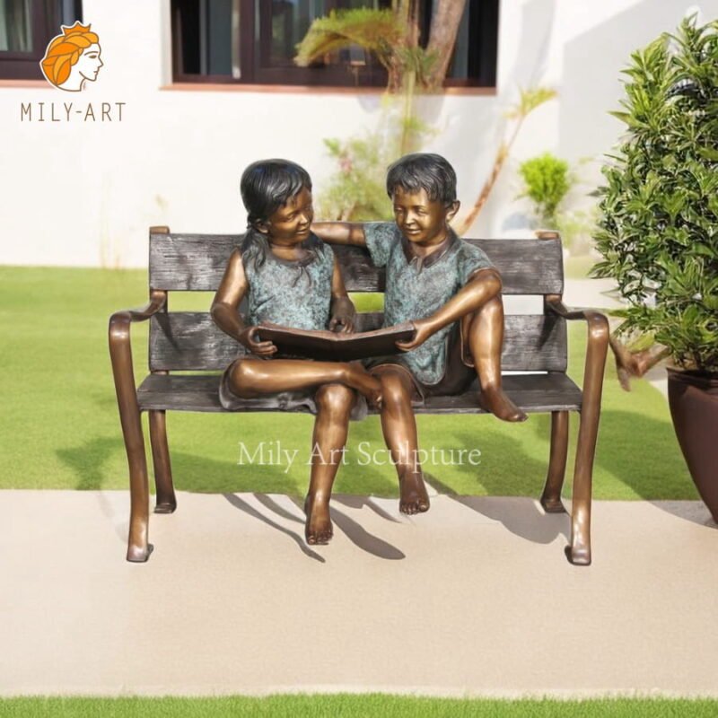 bronze boy and girl sclupture reading books on bench mlbs 174