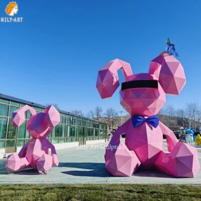 pink sitting metal rabbit sculpture