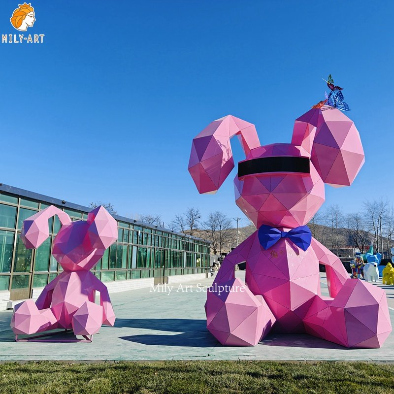 pink sitting metal rabbit sculpture
