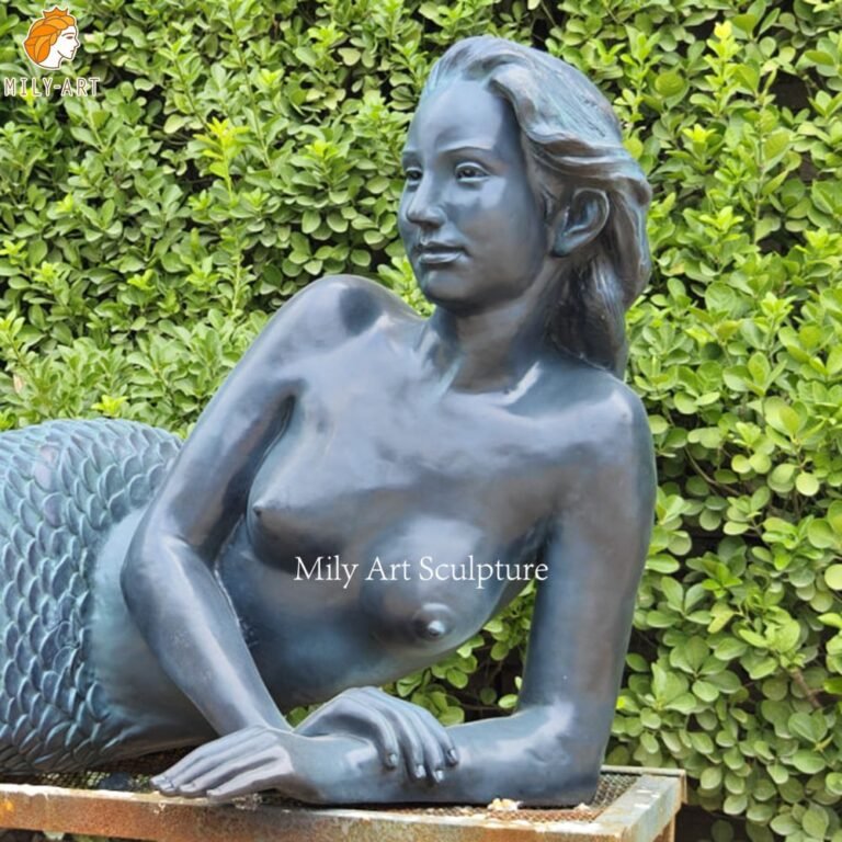 Detailed patina finish on an outdoor bronze mermaid sculpture