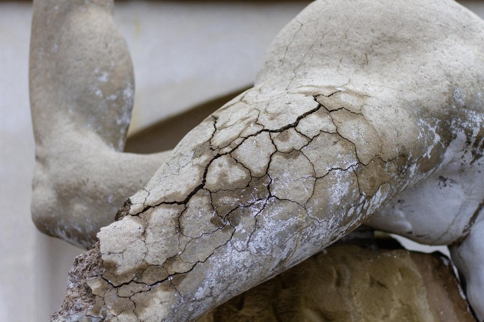 resin statue showing UV fading and surface cracking outdoors