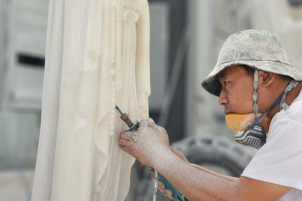 Mily artisan carving details on a marble Four Season statue